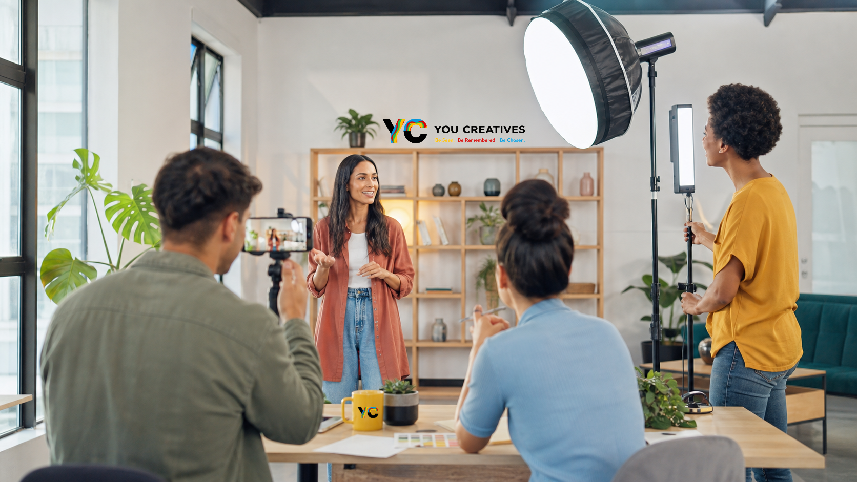 Presenter recording a video in a bright home studio with a small production crew