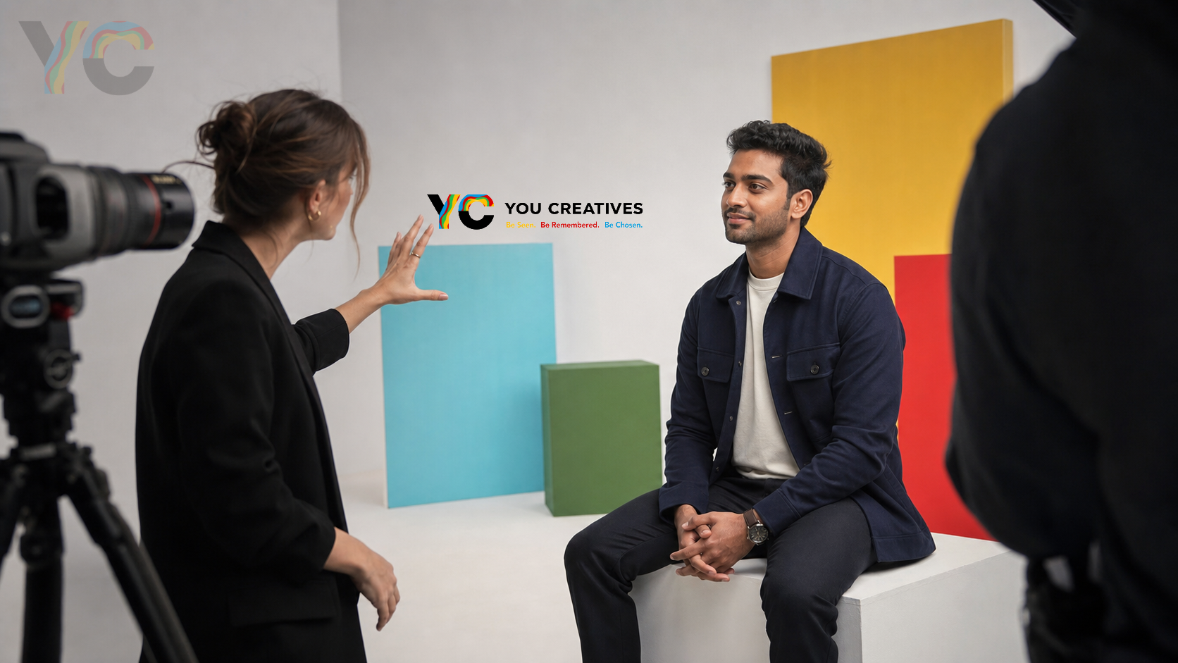 Founder being interviewed on a colourful set during a video shoot