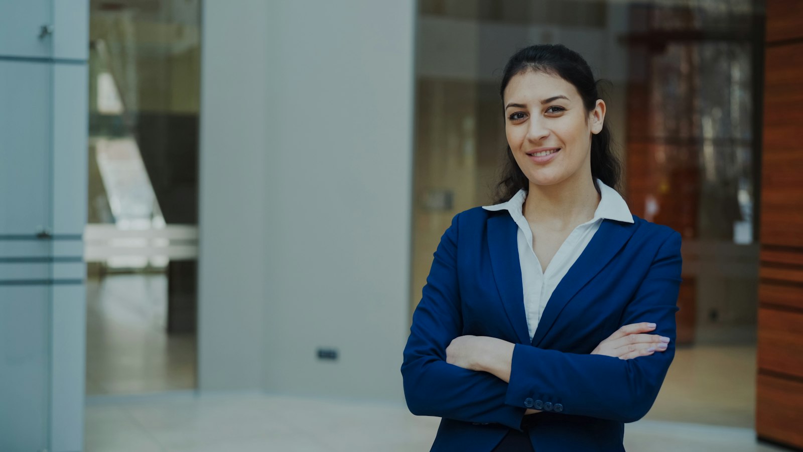 A confident businesswoman executive in a blue suit smiling